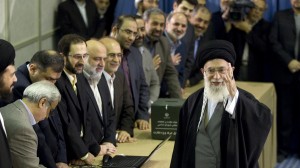 Iran's Supreme Leader Ayatollah Khamenei waves to the media after presenting his identification papers to cast his ballot in the parliamentary election in Tehran