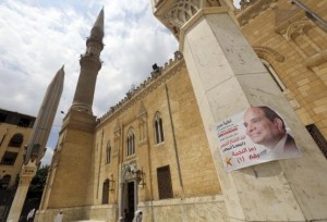 Election poster of Egypt's former army chief Abdel Fattah al-Sisi is seen on a column at Al-Hussein mosque in the old Islamic area of Cairo