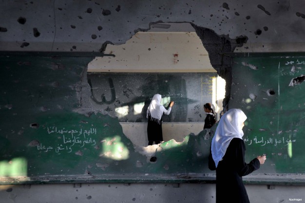 palestine-gaza-school-classroom-shelled-hole-in-the-wall-board