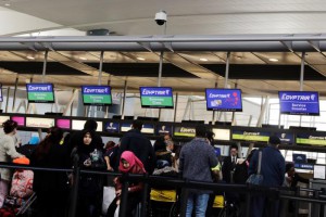 Travelers wait to check in at an Egypt Air counter at JFK International Airport in New York