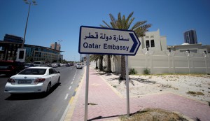 A sign indicating a route to Qatar embassy is seen in Manama